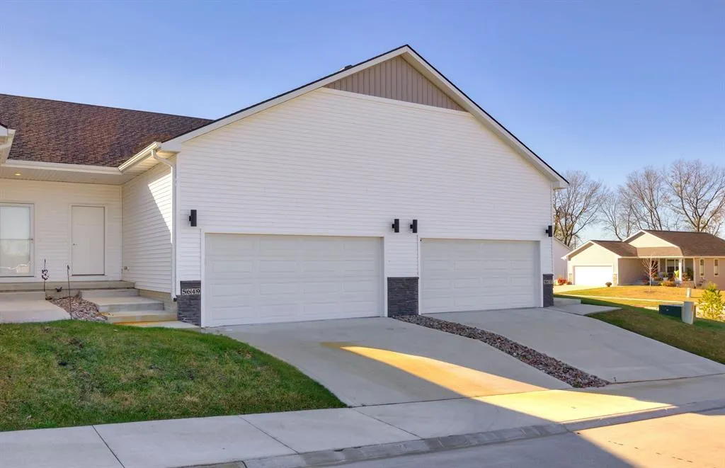 Exterior of 5649 Ponderosa Drive, a two-story townhome in Pleasant Hill, Iowa.